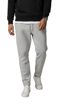 Person wearing gray sweatpants and a black top on a white background