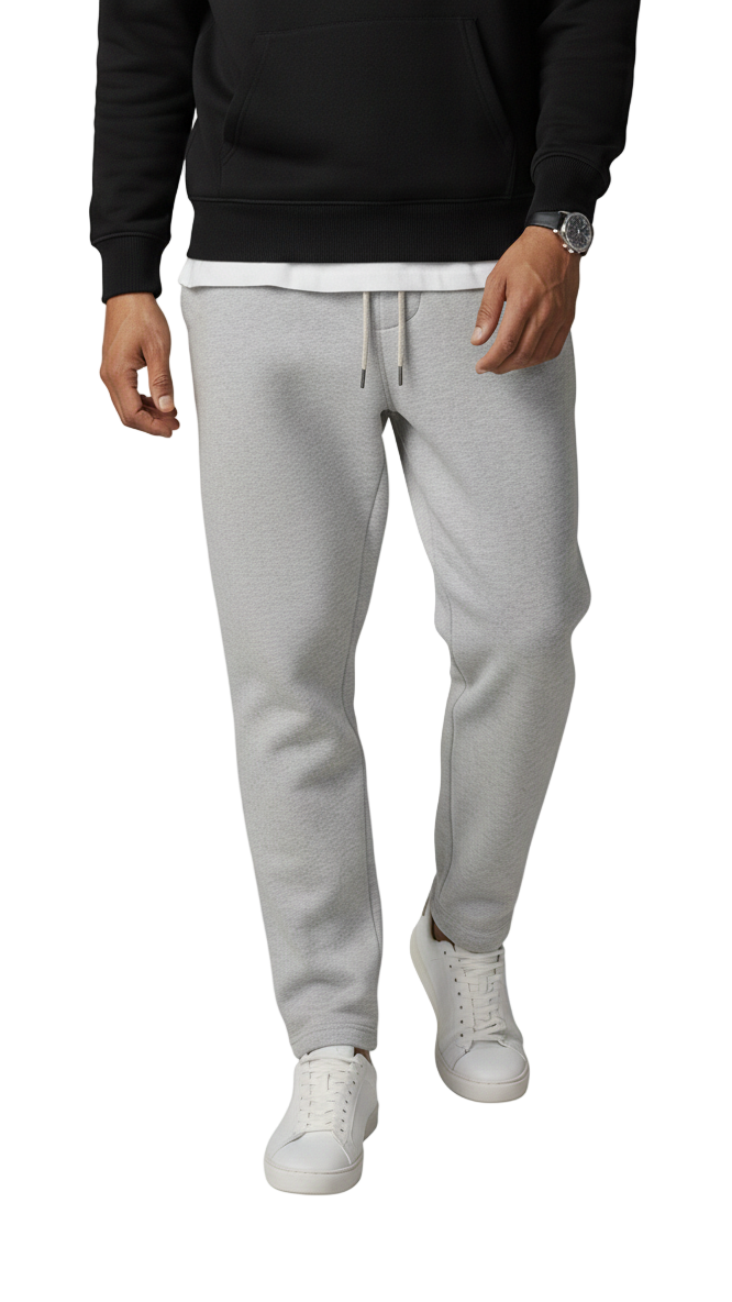 Person wearing gray sweatpants and a black top on a white background