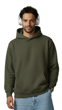 Man wearing an olive green hoodie and blue jeans with headphones on a plain background