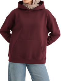 Person wearing a maroon hoodie and light blue jeans on a white background