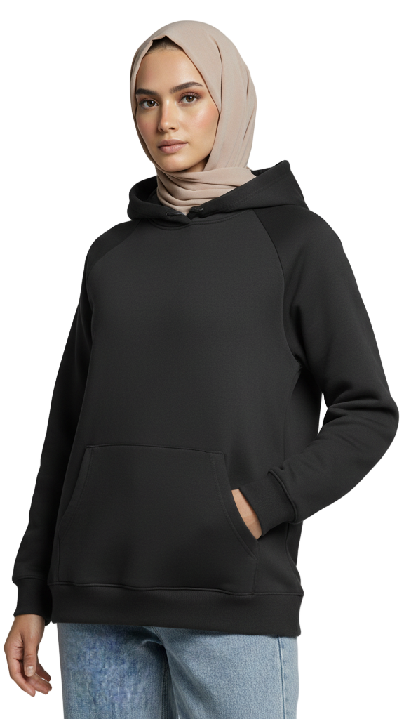 Person wearing a black hoodie and light blue jeans on a gray background